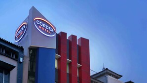 A hotel with a modern facade, featuring a prominent sign for 'CordeX Hotel' and a visible entrance with glass doors. - Cordex Hotel Ancol Jakarta (Jakarta)