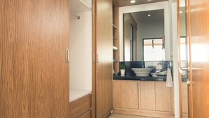 A modern bathroom with wooden cabinetry, a sink, and a mirror. - Ocean View Residence - Hotel Jepara (Jepara)
