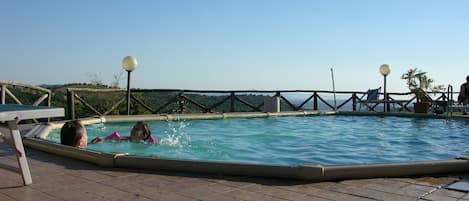 Seasonal outdoor pool, pool loungers