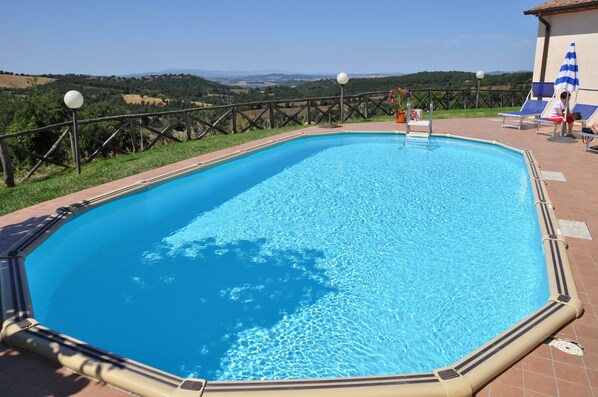 Seasonal outdoor pool, pool loungers