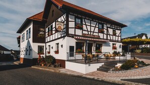 A traditional half-timbered building with a sign indicating it is a restaurant and hotel. - Landgasthaus Pfahl (Wershofen)