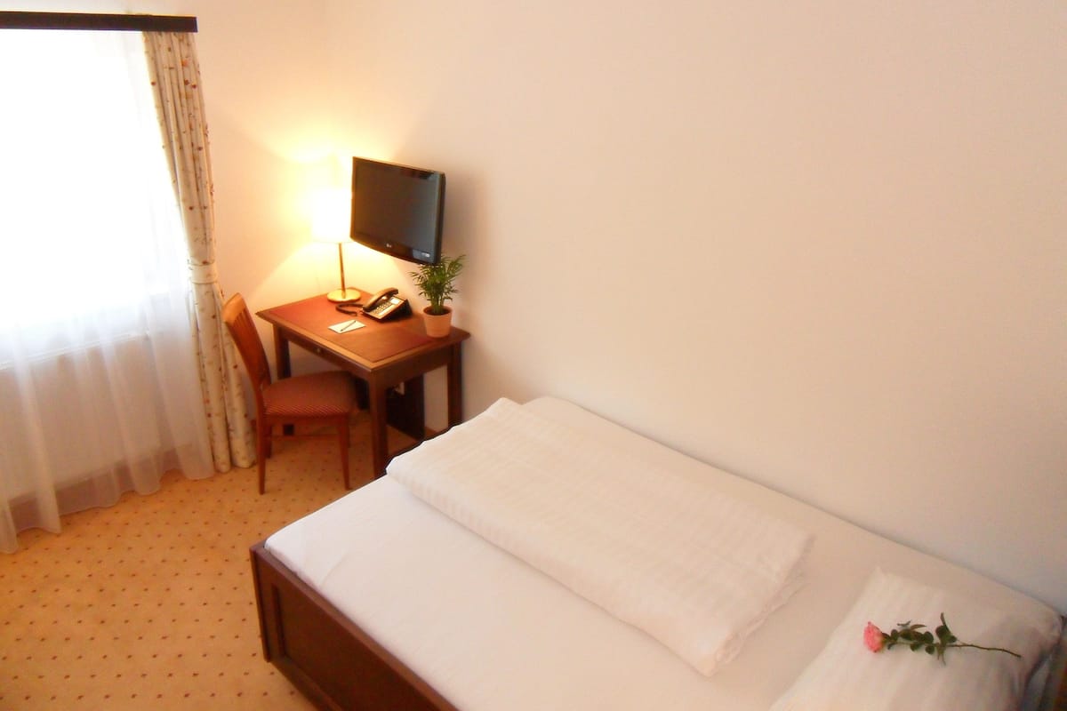 Premium bedding, desk, laptop workspace, blackout curtains