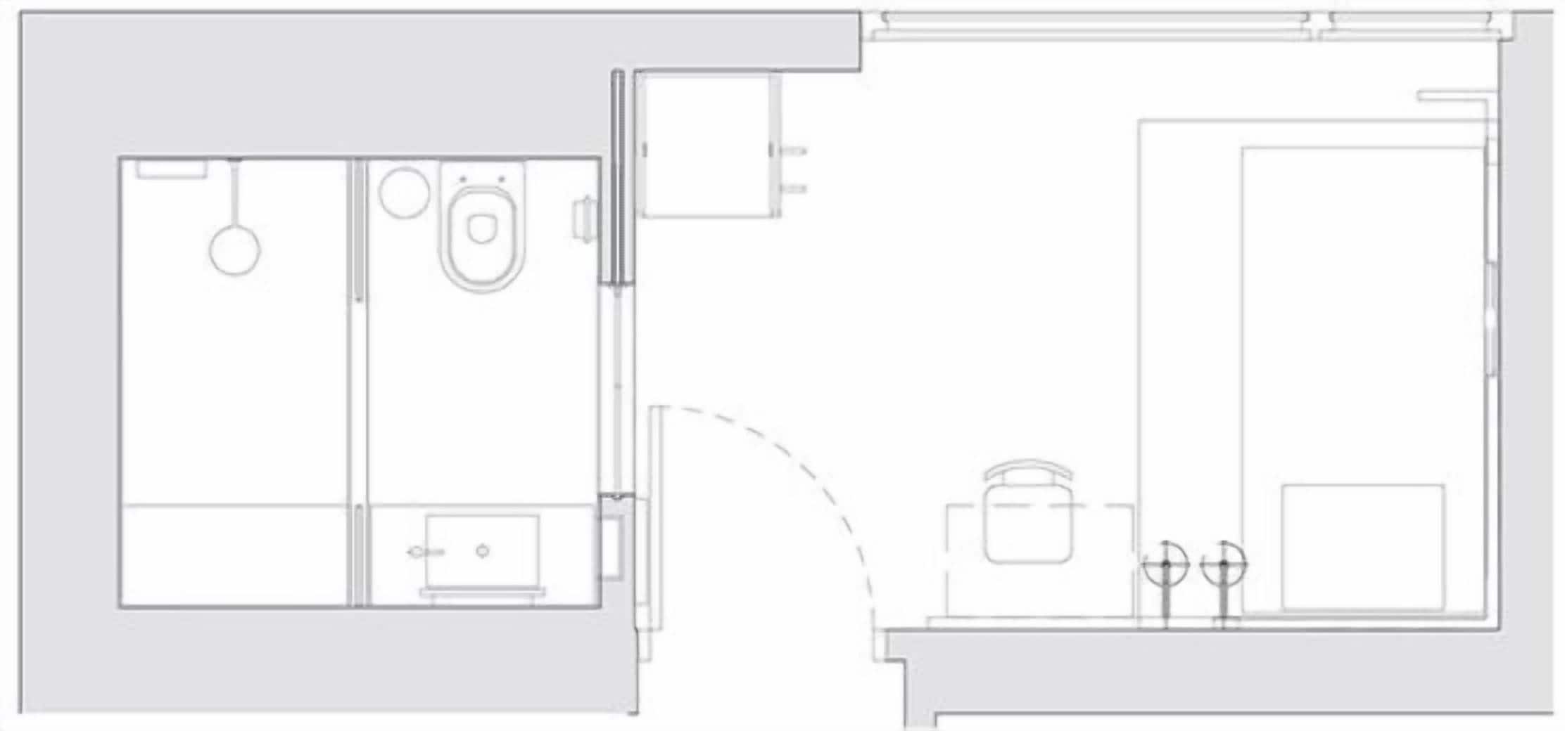 A floor plan of a hotel room with a bathroom, a kitchenette, and a seating area.
