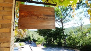 A wooden sign with "Casa Bons Aires" hanging under a pergola with green leaves. - Casa Bons Aires - Adults Only (Alcoy)