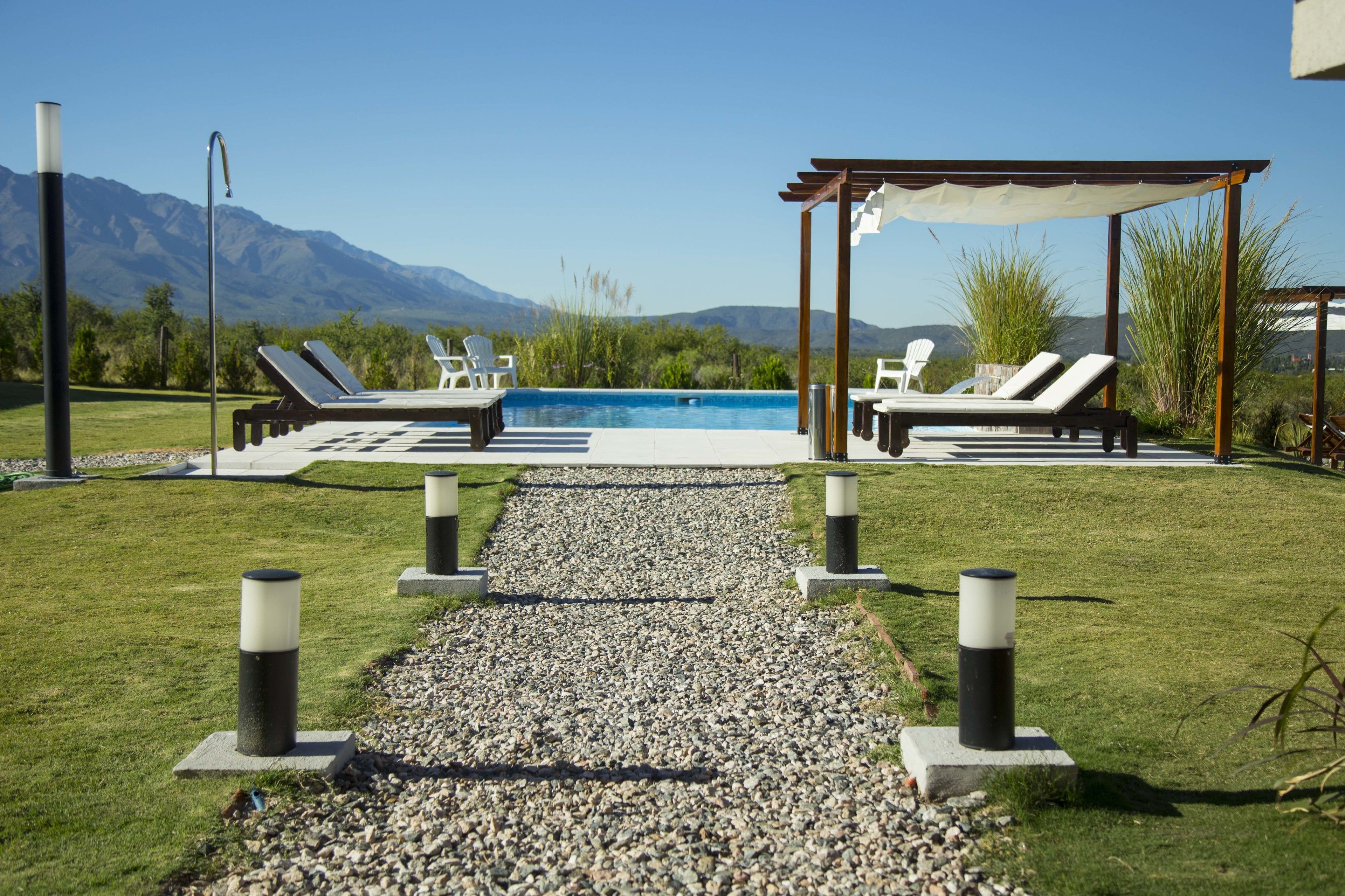 Outdoor pool, a waterfall pool, sun loungers