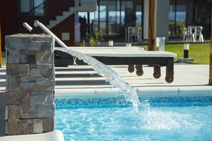 Outdoor pool, a waterfall pool, pool loungers