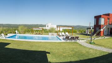 Outdoor pool, a waterfall pool, pool loungers
