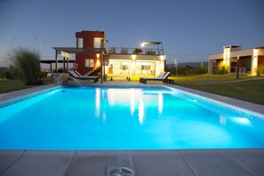 Outdoor pool, a waterfall pool, pool loungers