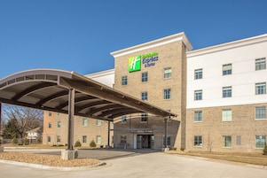 Edificio de Holiday Inn Express & Suites con entrada cubierta y fachada de ladrillo.