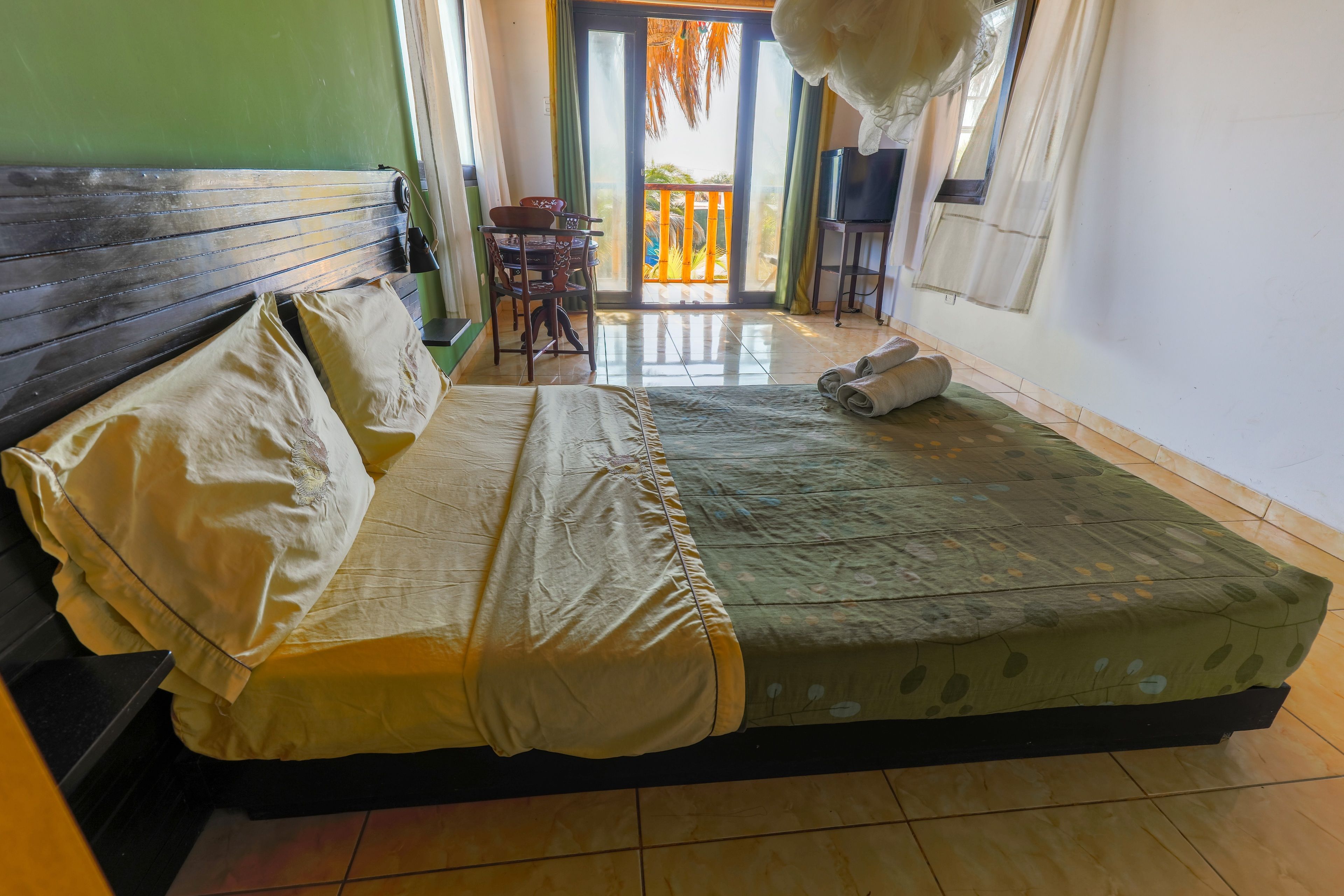 A room with a bed, a table, and a chair.