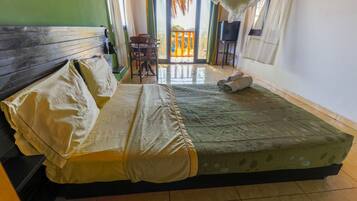 A room with a bed, a table, and a chair.