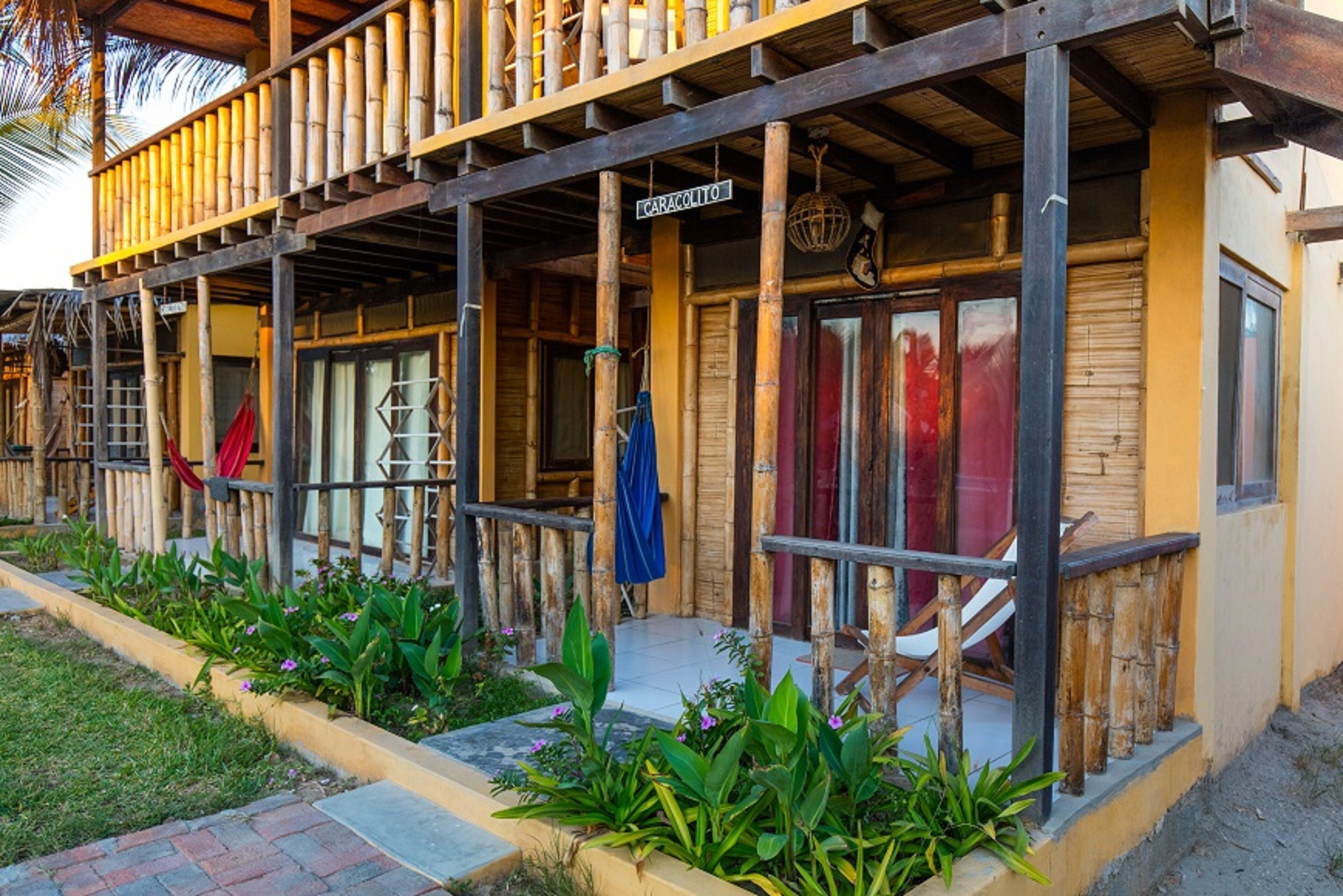 A wooden building with a balcony and a sign that reads "CARACOLITO".