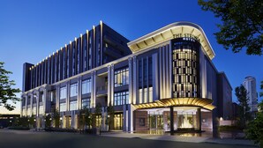A modern hotel with a curved facade, multiple floors, and a prominent entrance. - The Strings Hotel Nagoya (Nagoya)