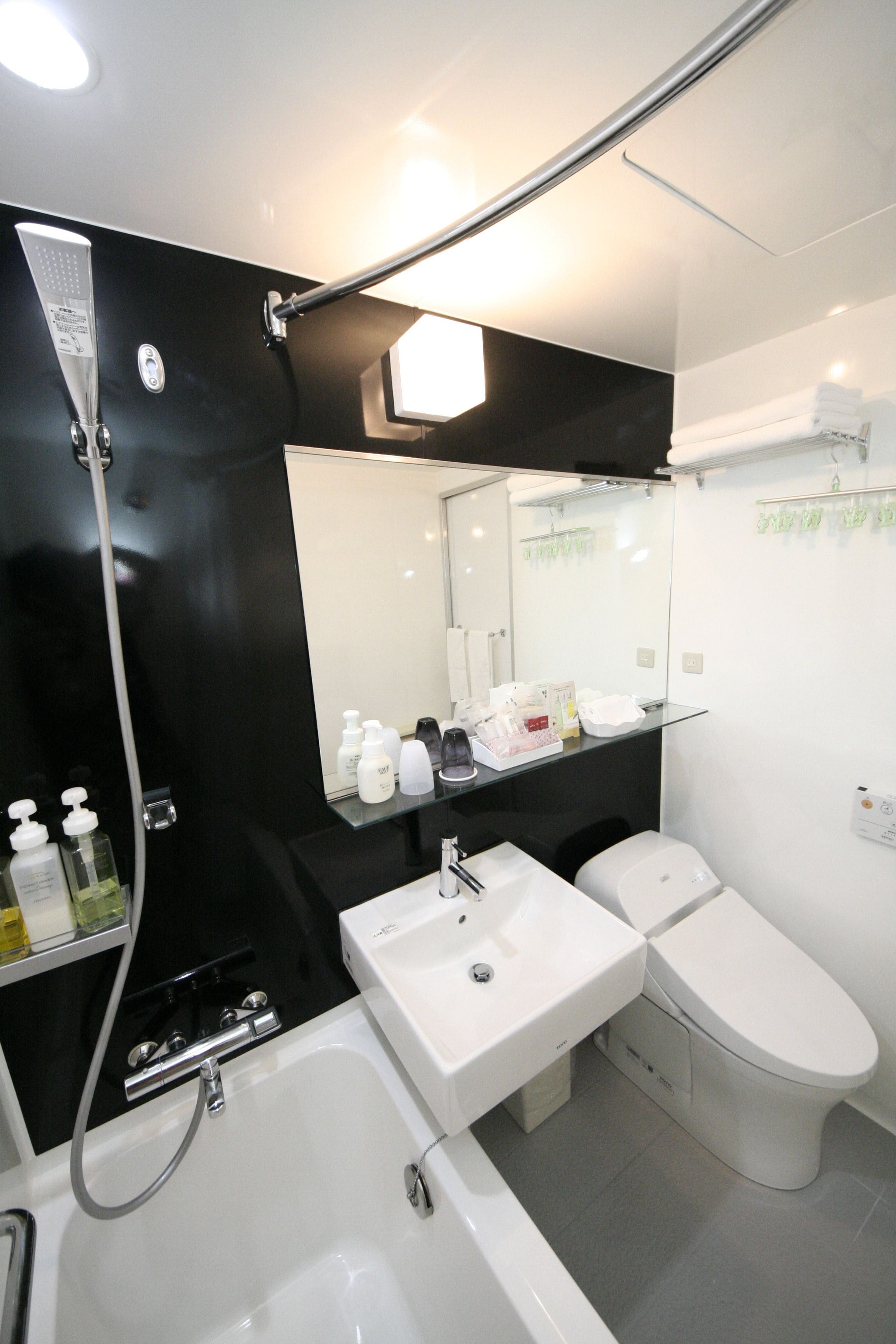 combined shower/bathtub, designer toiletries, hair dryer, slippers