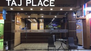 The entrance to Taj Place Residency with a reception desk, seating area, and a glass door. - Taj Place Residency (Pattaya)