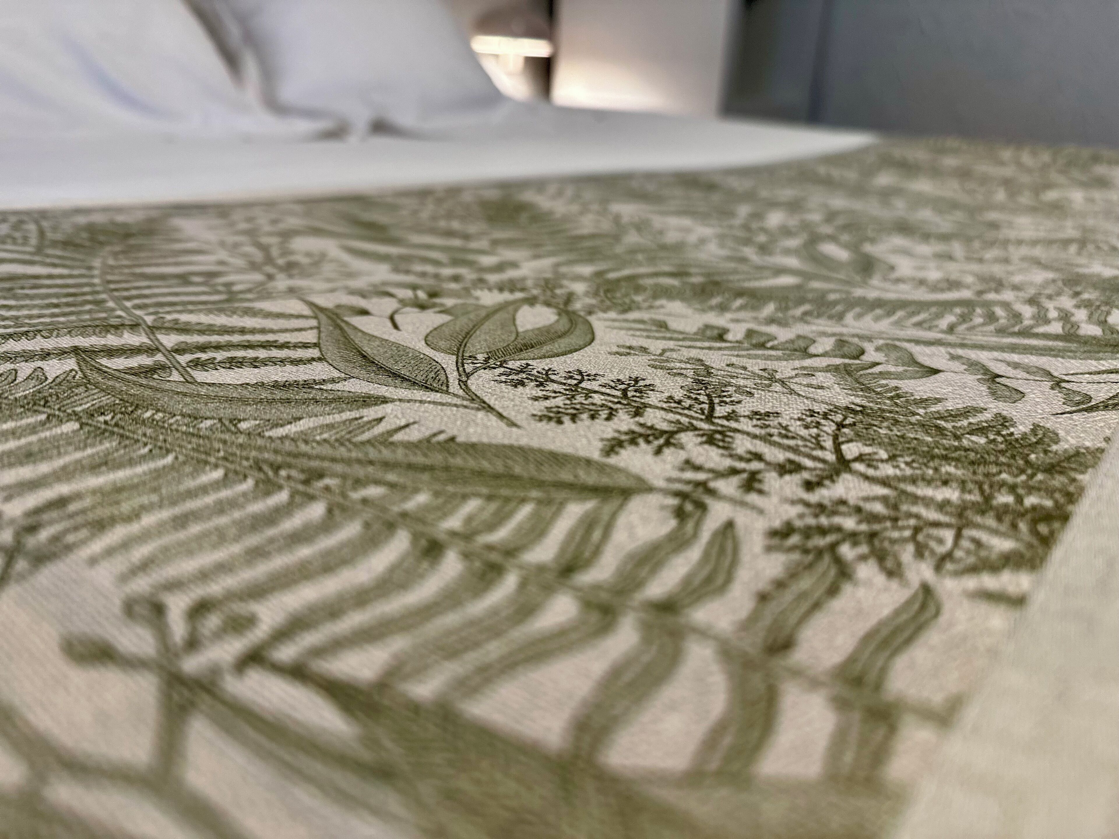 Primer plano de una cama con un intrincado diseño bordado.