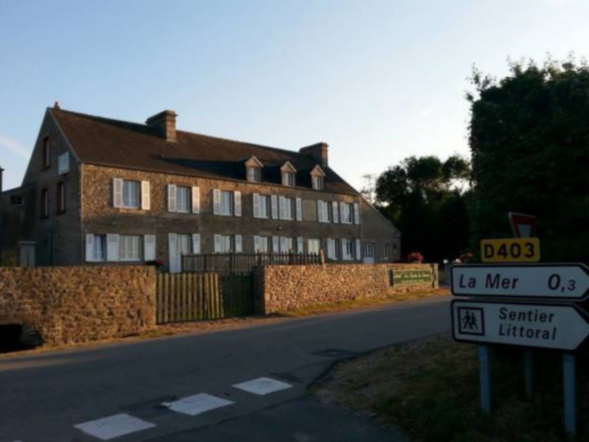 A stone building with a traditional architectural style, featuring multiple windows and a stone facade.