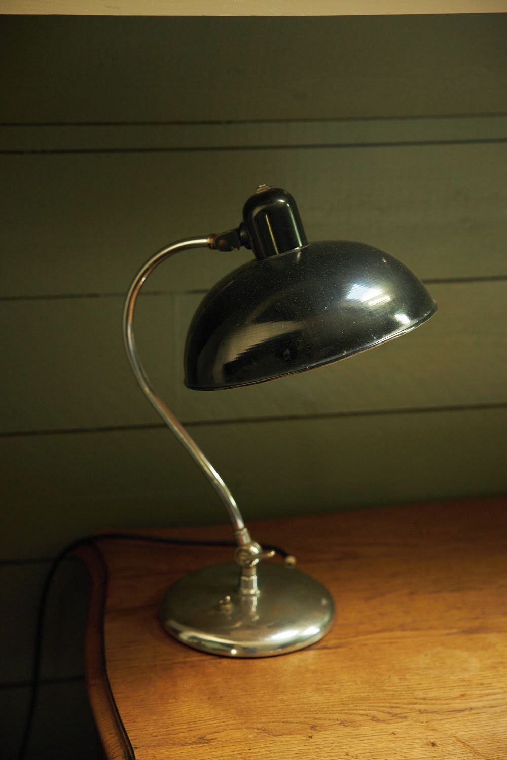 A desk lamp with a metallic finish, a curved neck, and a base.