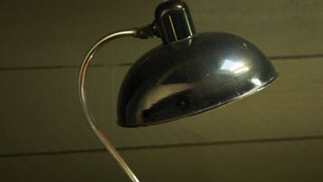 A desk lamp with a metallic finish, a curved neck, and a base.
