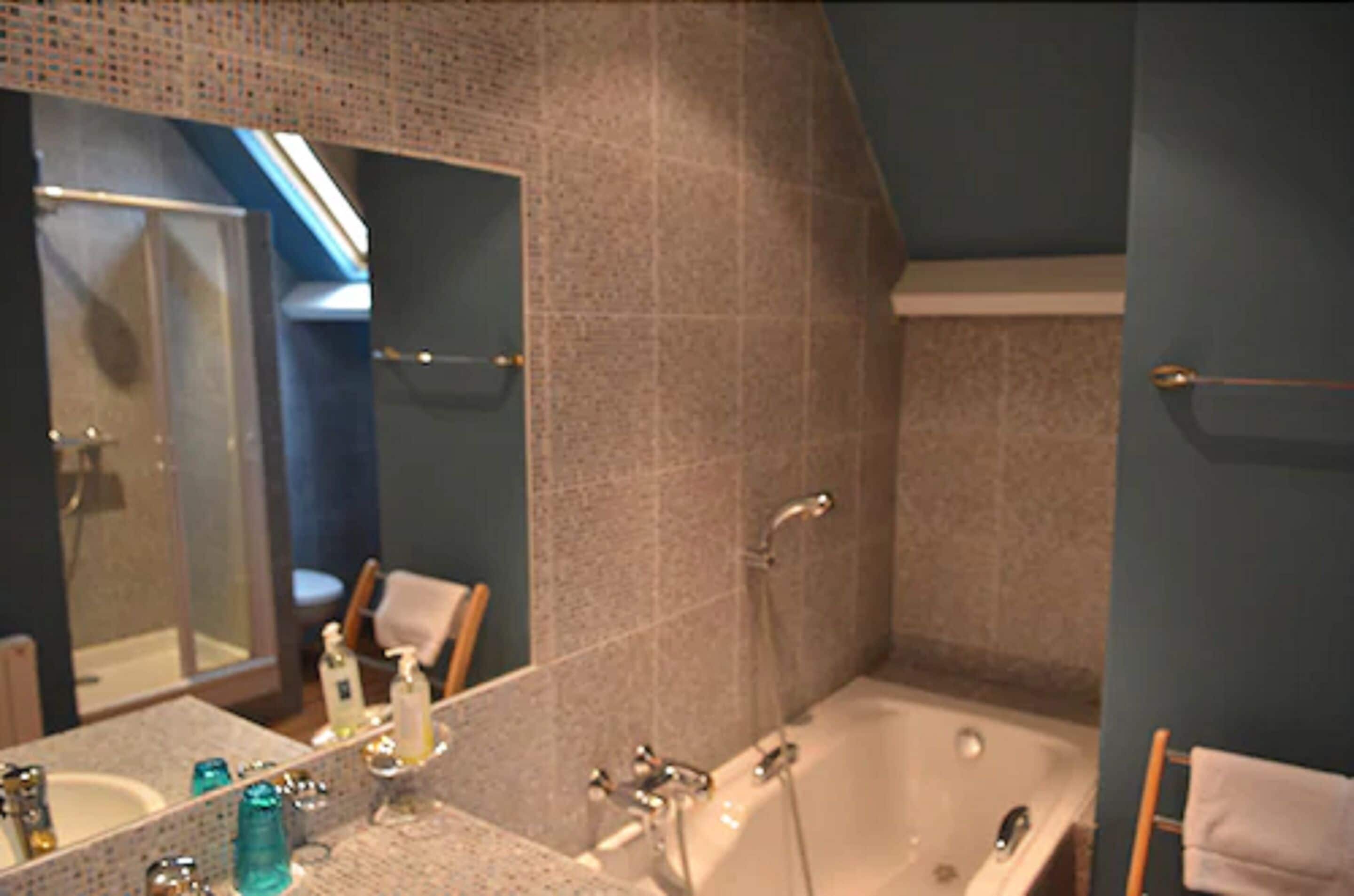 deluxe room, 1 king bed | bathroom | free toiletries, hair dryer, towels