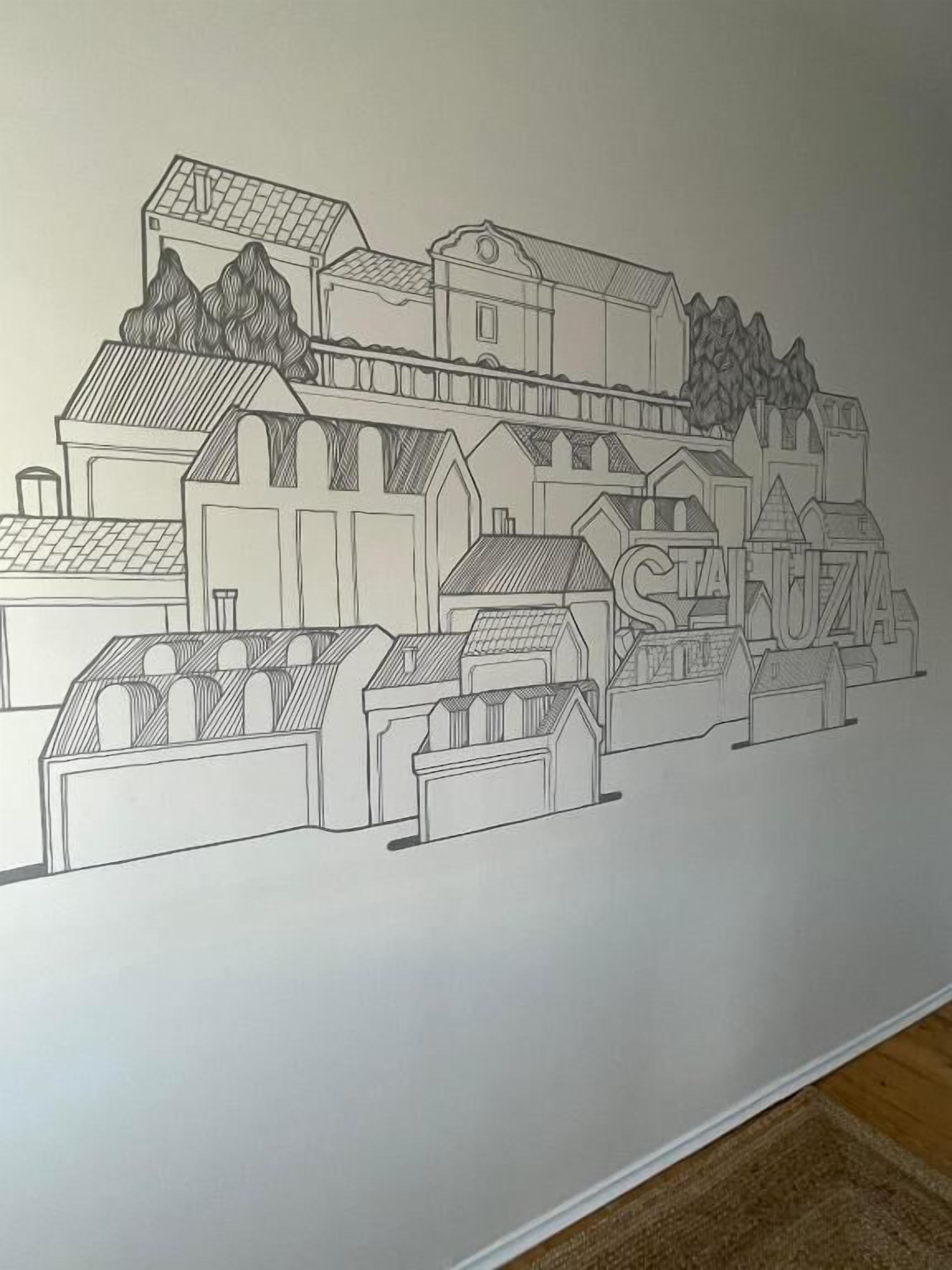 A detailed architectural drawing of a town with various buildings, including houses and a church.