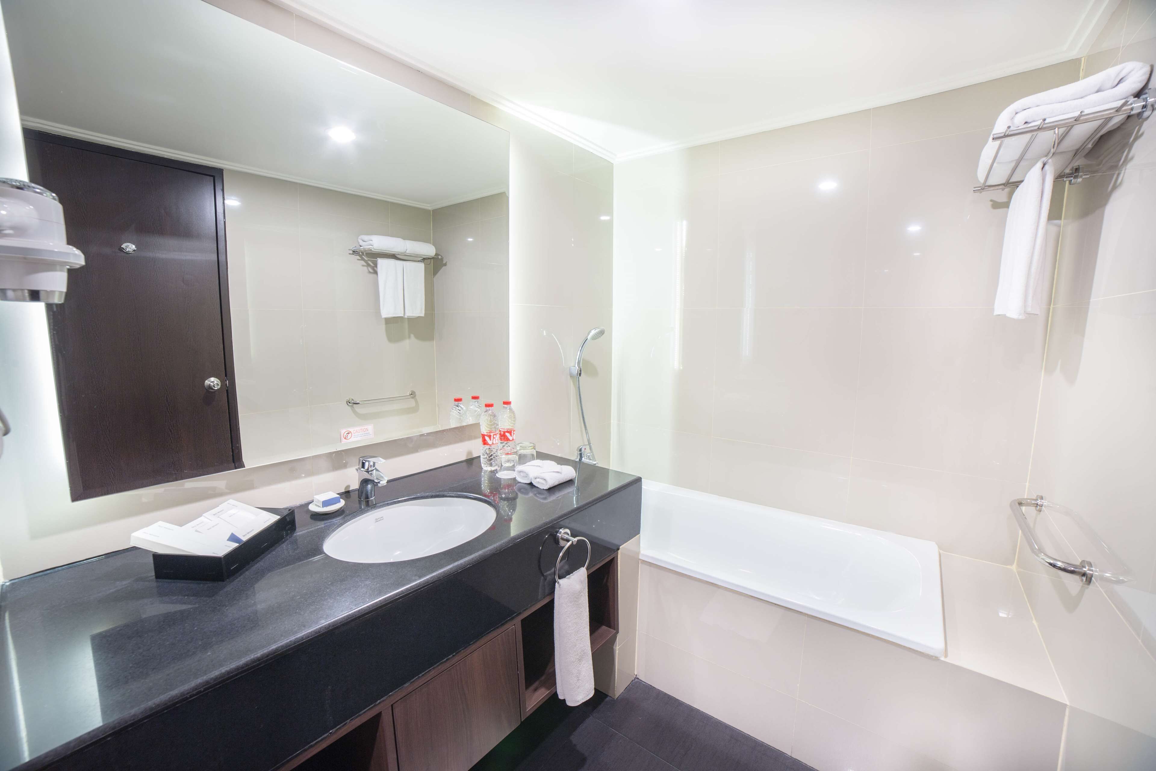 suite, 1 king bed, non smoking, city view | bathroom | shower, rainfall showerhead, hair dryer, slippers