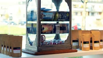 A display of various packaged goods, including snacks and preserves, arranged on shelves and a central display case.