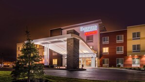 A multi-story hotel with a covered entrance and a marquee sign. - Fairfield Inn & Suites Utica (Utica)