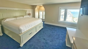 A bedroom with a large bed, a dresser, a nightstand, and a window with a view of the sea. - The Winthrop Arms Hotel And Restaurant (Winthrop)