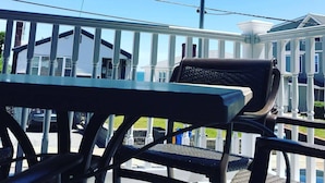 A balcony with a view of a house and a clear sky. - The Winthrop Arms Hotel And Restaurant (Winthrop)