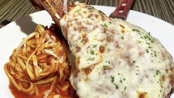 A plate with a meat dish and pasta.