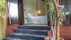 A staircase leading to a bed with a green wall and a potted plant. - Villa Anjing 2 (Nusa Dua)