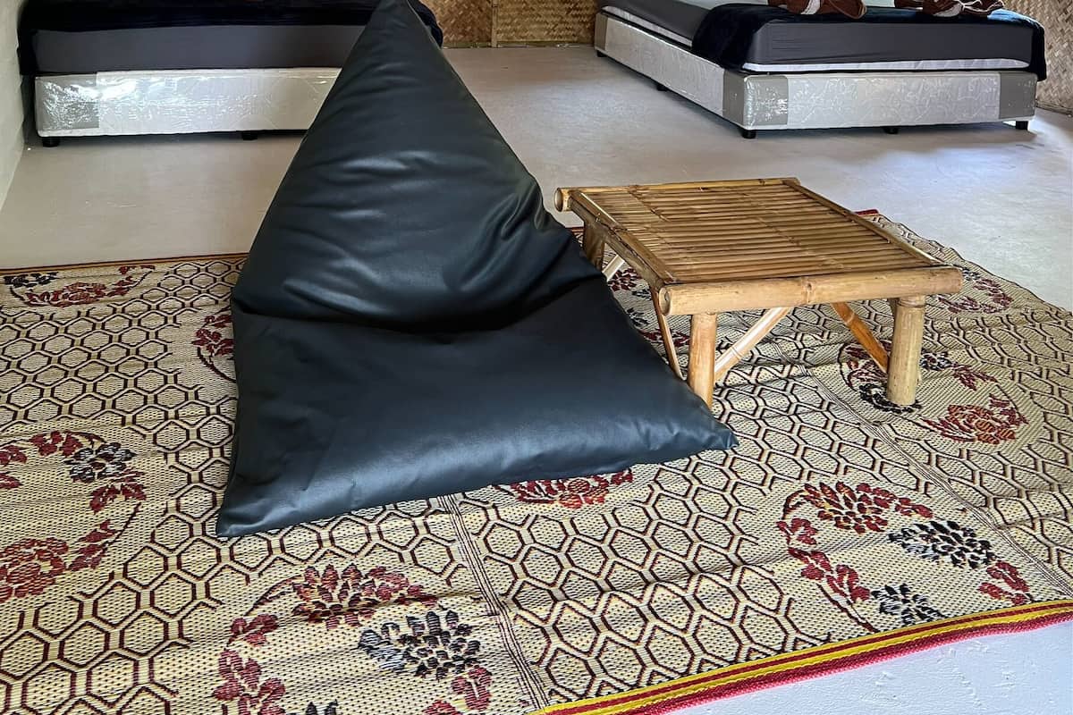 A room with a bed, a sofa, and a small table.