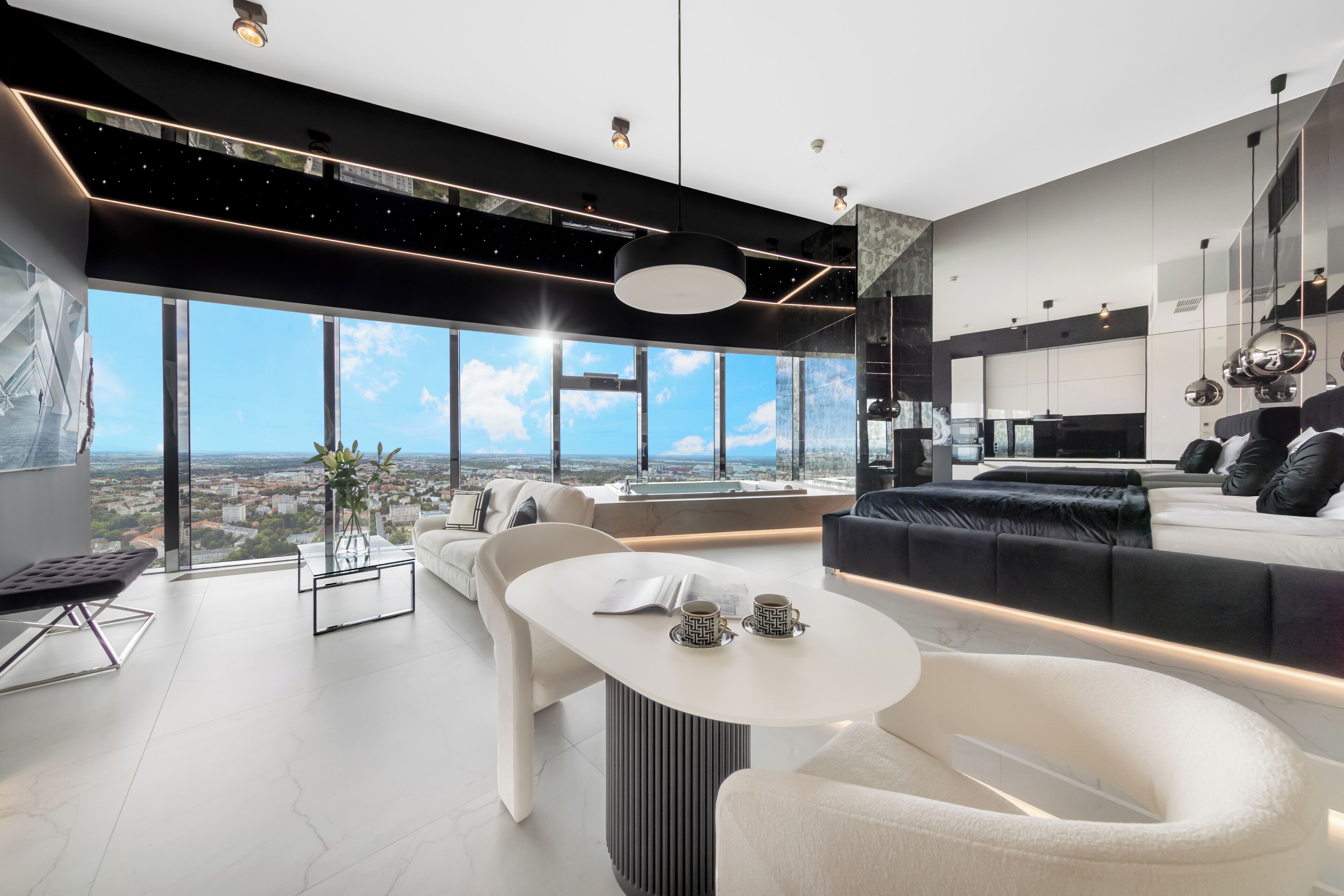 A modern living room with a large window, a sofa, a coffee table, and a dining area.