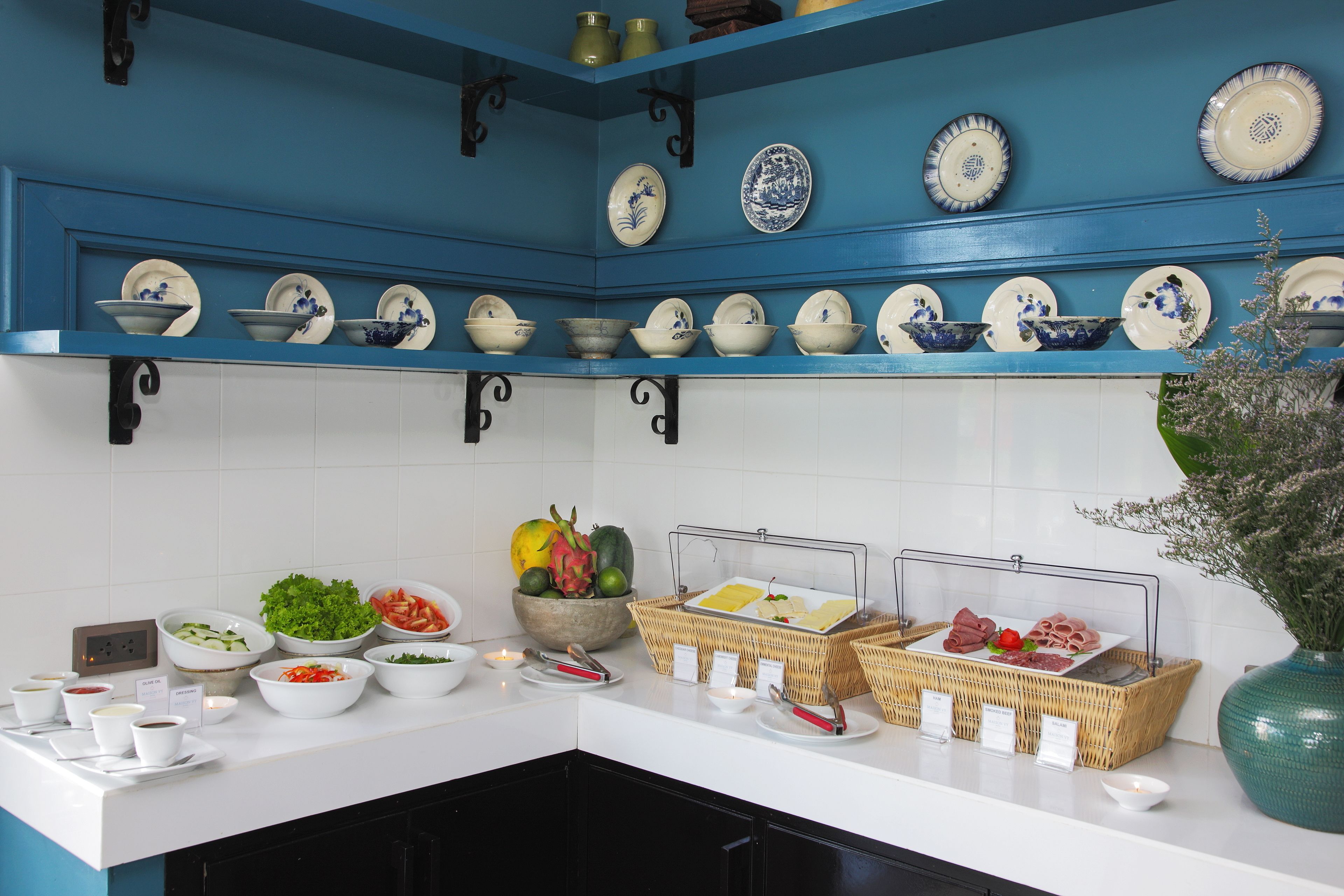 A buffet setup with various food items and dishes.