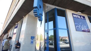 A hotel entrance with a blue awning and a sign reading "HOTEL R." - Hotel Alba (Soria)