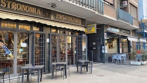 A storefront with a sign reading "Pasticceria" and outdoor seating. - Black & White G&G (Rome)