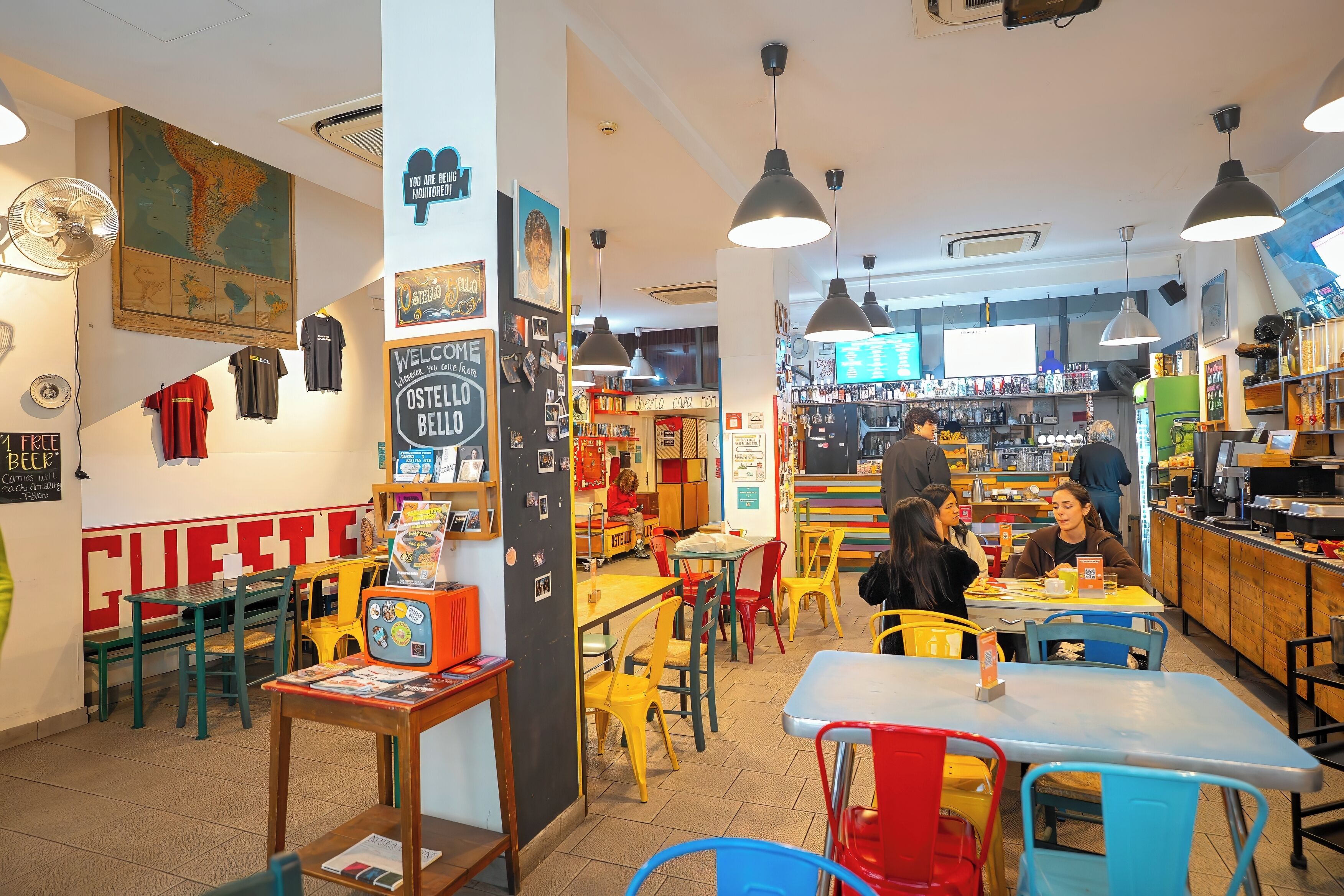 A restaurant interior with tables, chairs, and a bar area.