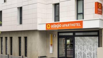 Un immeuble moderne avec une enseigne indiquant « Adagio Access Aparthotel ».