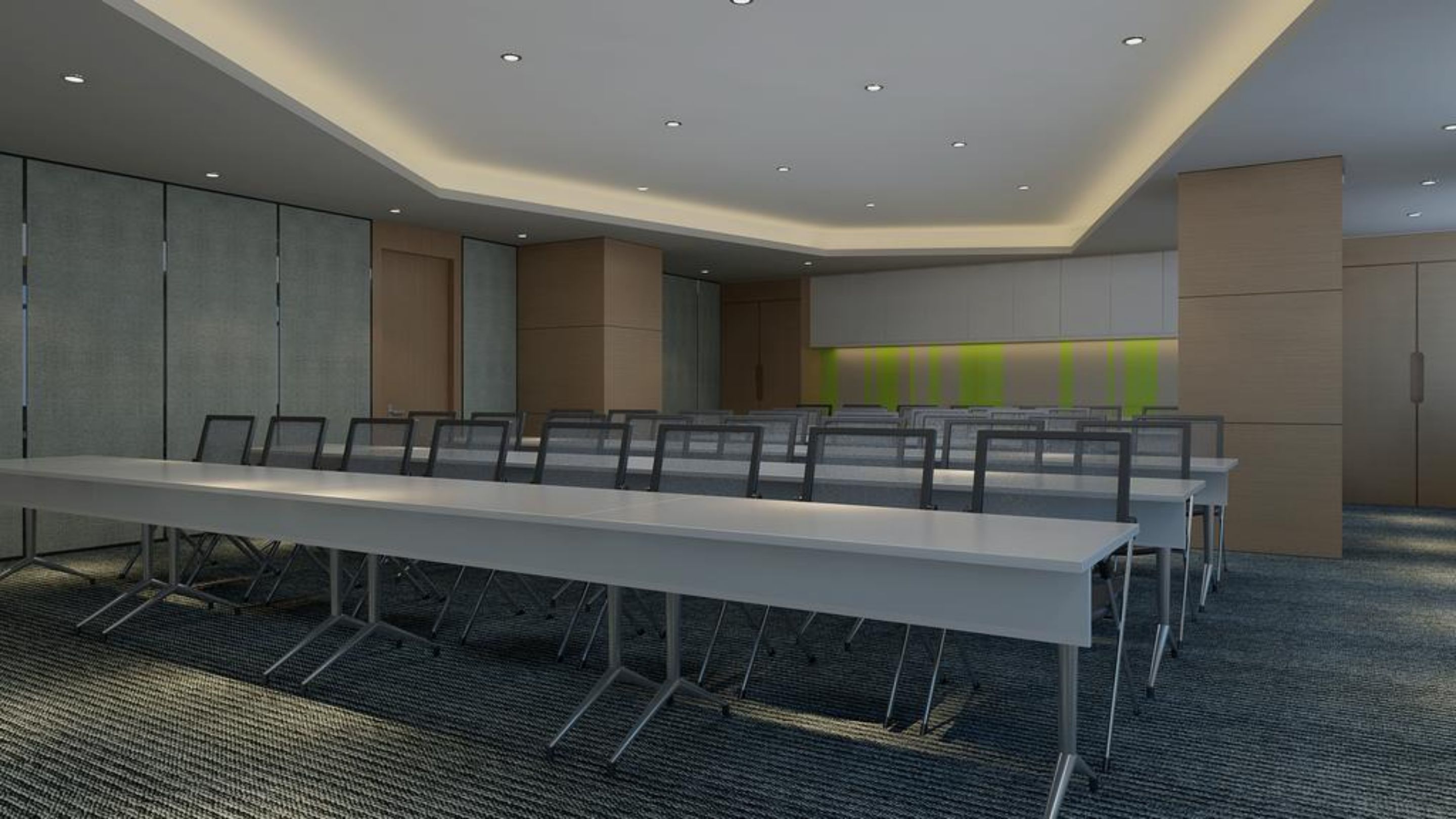 A conference room with a long table and chairs, recessed ceiling lights, and a carpeted floor.