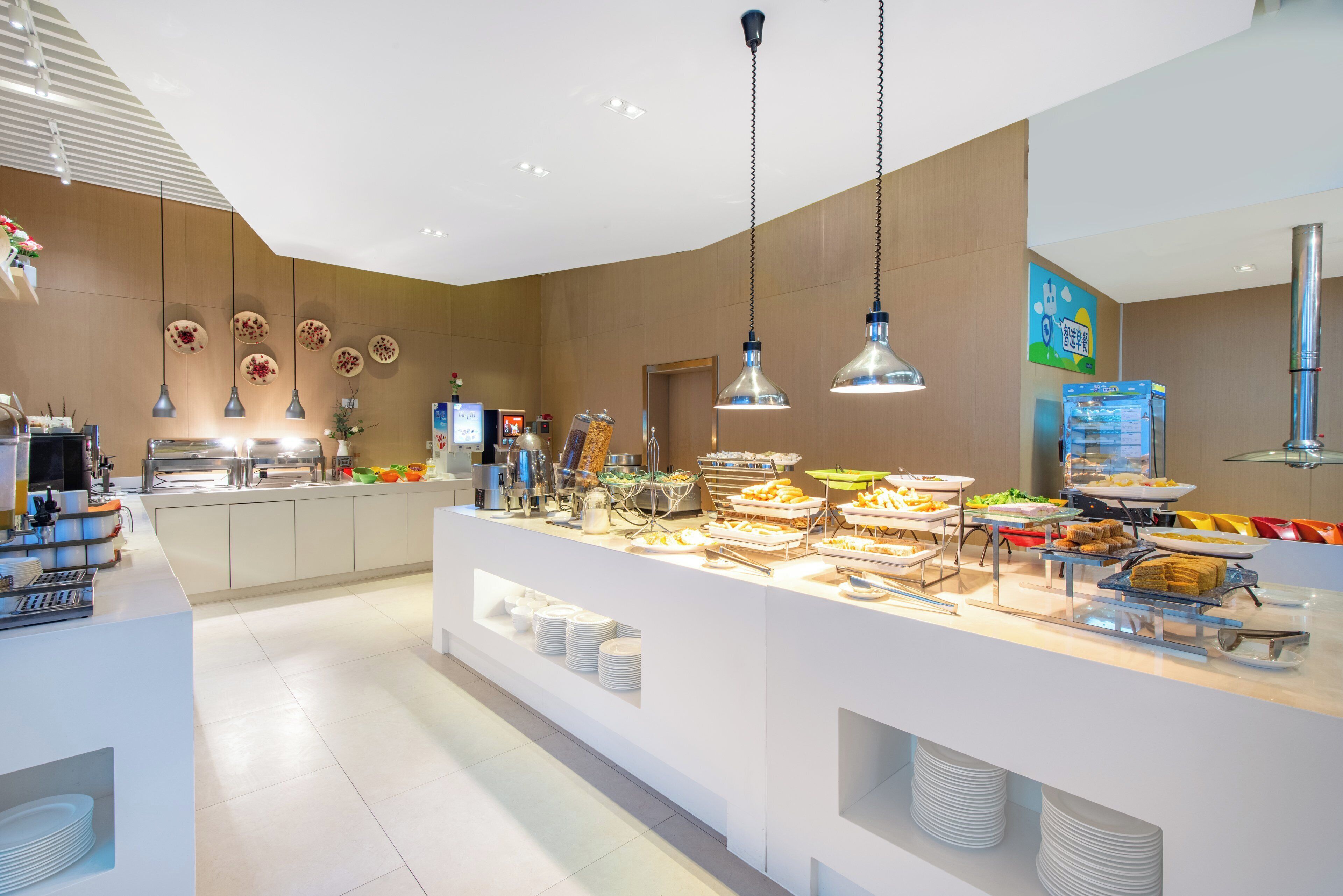 A modern breakfast buffet with a variety of food options, a coffee station, and a clean, well-lit interior.