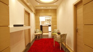 A hallway with a red carpet, wooden walls, and a kitchen area in the background. - City Code Exclusive (Belgrade)
