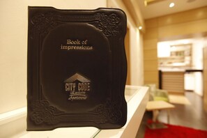 A black book titled "Book of impressions" with "CITY CODE Exclusive Apartments" embossed on it. - City Code Exclusive (Belgrade)