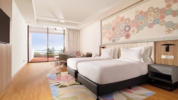 A modern hotel room with two beds, a large window, a balcony, and a decorative wall.
