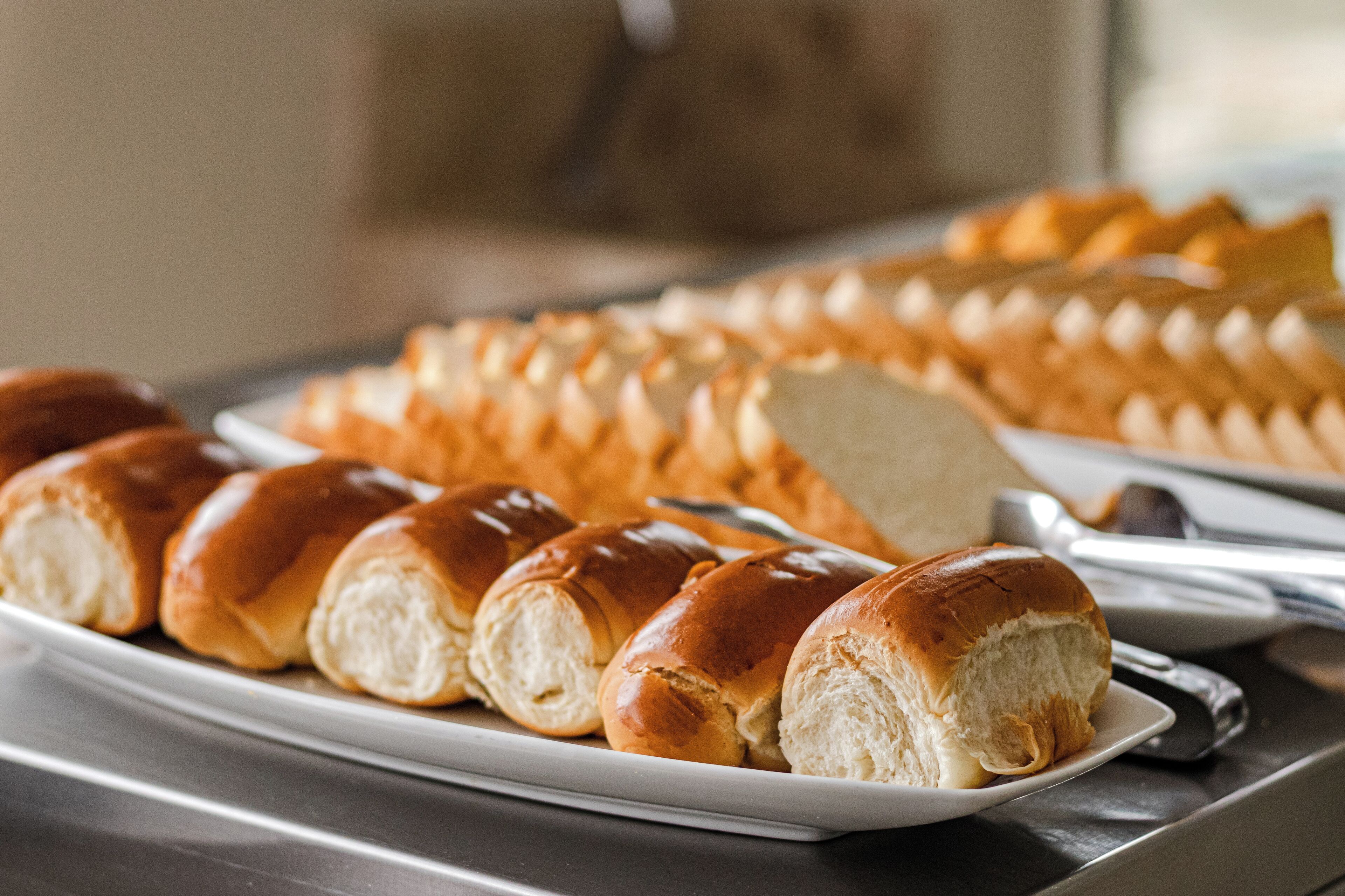 A plate of freshly baked bread rolls on a tray.