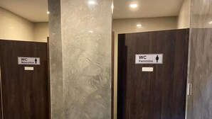 A restroom with two doors, each marked with a WC sign indicating a male and female restroom.