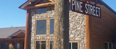 A building with a stone facade and wooden beams, labeled 'SUBLETTE AVE' and 'PINE STREET'.