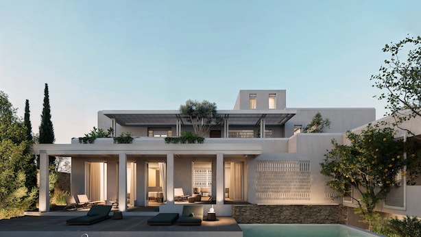 Une maison moderne dotée d’une piscine, d’un espace salon extérieur et d’un mur en pierre.
