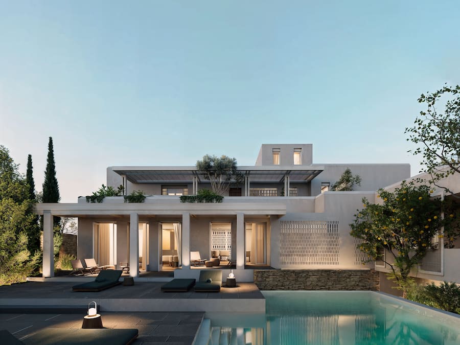 Una casa moderna con piscina, mobiliario de exterior y un muro de piedra.