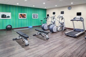 A gym with treadmills, elliptical machines, and a bench. - Holiday Inn Express & Suites Coldwater by IHG (Coldwater)